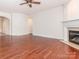 Bright living room featuring hardwood floors, fireplace, and a ceiling fan at 43014 Mimosa Ct, Indian Land, SC 29707