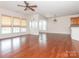 Open concept living space with hardwood floors, large windows, and an archway into the kitchen at 43014 Mimosa Ct, Indian Land, SC 29707