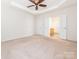 Large main bedroom features trey ceiling with a ceiling fan and ensuite bathroom entry at 43014 Mimosa Ct, Indian Land, SC 29707