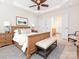Spacious main bedroom has a tray ceiling, a ceiling fan, carpet and an ensuite bathroom at 43014 Mimosa Ct, Indian Land, SC 29707