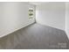 Clean, carpeted bedroom features a bright window at 4437 Devonhill Ln, Charlotte, NC 28269