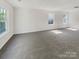 Spacious bonus room with neutral carpet and plenty of natural light from multiple windows at 4437 Devonhill Ln, Charlotte, NC 28269