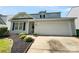 Charming home features a 2-car garage and beautiful landscaping with a well-maintained lawn and decorative bushes at 4437 Devonhill Ln, Charlotte, NC 28269