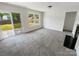 Cozy living room featuring a fireplace and sliding glass doors to the backyard at 4437 Devonhill Ln, Charlotte, NC 28269