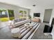 Bright living room featuring a fireplace, modern furniture, and sliding glass doors to the backyard at 4437 Devonhill Ln, Charlotte, NC 28269