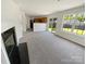 Open living room with fireplace, sliding glass doors, and abundant natural light at 4437 Devonhill Ln, Charlotte, NC 28269
