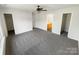 The primary bedroom with ceiling fan, a view to the en-suite bathroom, and closets at 4437 Devonhill Ln, Charlotte, NC 28269