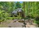 Picturesque backyard with deck, screened porch, fire pit and wooded setting at 4516 Stryker Dr, Matthews, NC 28104