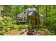 Picturesque backyard with deck, screened porch, fire pit and wooded setting at 4516 Stryker Dr, Matthews, NC 28104