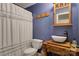 Bathroom featuring a toilet, vessel sink on wood vanity, and tiled shower with curtain at 4516 Stryker Dr, Matthews, NC 28104