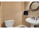Powder room features a toilet, a pedestal sink, and a round mirror at 4516 Stryker Dr, Matthews, NC 28104