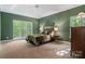 Serene bedroom with a trey ceiling, carpet, natural light, and a comfortable bed with accent pillows at 4516 Stryker Dr, Matthews, NC 28104