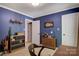 Bedroom featuring blue walls, a closet and built-in shelving at 4516 Stryker Dr, Matthews, NC 28104