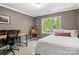 Bedroom with a large window, a bed, and a desk, offering ample space for relaxation and productivity at 4516 Stryker Dr, Matthews, NC 28104