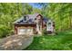 Charming brick home with a two-car garage, manicured lawn and verdant surrounding trees at 4516 Stryker Dr, Matthews, NC 28104