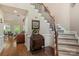 Inviting foyer features a staircase, hardwood floors, and an adjacent view into living room at 4516 Stryker Dr, Matthews, NC 28104