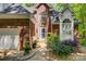 Close up view of the beautiful front entrance surrounded by lush landscaping and plants at 4516 Stryker Dr, Matthews, NC 28104