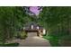 Home exterior at dusk, showing lush landscaping, a driveway, and a two car garage at 4516 Stryker Dr, Matthews, NC 28104