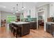 Spacious kitchen boasts hardwood floors, a large island with seating, and modern pendant lighting at 4516 Stryker Dr, Matthews, NC 28104