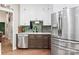 Charming kitchen featuring stainless steel appliances, a green backsplash, and white upper cabinets at 4516 Stryker Dr, Matthews, NC 28104
