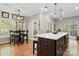 Kitchen with an island, stool seating and lots of natural light coming from the windows at 4516 Stryker Dr, Matthews, NC 28104