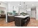 Spacious kitchen featuring a large island, seating, pendant lights and stainless steel appliances at 4516 Stryker Dr, Matthews, NC 28104