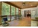 Relaxing screened-in porch with wood floors, a ceiling fan and views of the wooded yard at 4516 Stryker Dr, Matthews, NC 28104