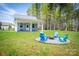 Backyard featuring a cozy fire pit with Adirondack chairs, ideal for enjoying the outdoors at 4594 N Wynswept Dr, Maiden, NC 28650
