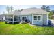 Beautiful backyard showcasing well-maintained lawn, patio area with grill, and view of back exterior at 4594 N Wynswept Dr, Maiden, NC 28650