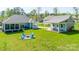 Expansive backyard with outdoor seating area and fire pit surrounded by Adirondack chairs at 4594 N Wynswept Dr, Maiden, NC 28650