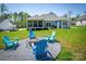 Backyard with fire pit area and blue Adirondack chairs, perfect for outdoor gatherings at 4594 N Wynswept Dr, Maiden, NC 28650