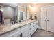 Bathroom featuring double sinks with granite countertops, white cabinets and two large mirrors at 4594 N Wynswept Dr, Maiden, NC 28650