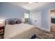 A bedroom with neutral blue walls, an iron bed and a double door closet at 4594 N Wynswept Dr, Maiden, NC 28650