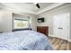 A bedroom boasts a seating area, ceiling fan and a wooden dresser with a television mounted above it at 4594 N Wynswept Dr, Maiden, NC 28650
