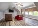 Comfortable bonus room with wood floors, ceiling fan, recliner and natural light at 4594 N Wynswept Dr, Maiden, NC 28650