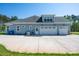 Rear exterior of home featuring long driveway and three-car garage at 4594 N Wynswept Dr, Maiden, NC 28650