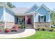 Charming front of home with stone accents, beautiful landscaping, and porch at 4594 N Wynswept Dr, Maiden, NC 28650