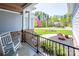 Inviting front porch with rocking chairs, black metal railings, and views of landscaped front yard with an American flag at 4594 N Wynswept Dr, Maiden, NC 28650