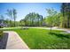 Lush front yard with a well-manicured lawn, mature trees, and a sidewalk leading to the property at 4594 N Wynswept Dr, Maiden, NC 28650