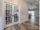 Home office with glass french doors, and views to the common areas of the house beyond at 4594 N Wynswept Dr, Maiden, NC 28650