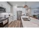 Modern kitchen with white cabinets, stainless steel appliances, and breakfast bar area at 4594 N Wynswept Dr, Maiden, NC 28650