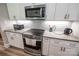 A well-equipped kitchen features modern appliances, white cabinets, and a granite countertop at 4594 N Wynswept Dr, Maiden, NC 28650