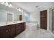 Main bathroom with soaking tub, double vanity, and dark wood cabinetry for ample storage at 5025 Willing Ct, Fort Mill, SC 29707
