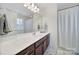 Well-lit bathroom featuring a large mirror, spacious vanity, and a shower with stylish curtain at 5025 Willing Ct, Fort Mill, SC 29707