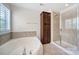 Bright bathroom features a soaking tub, separate shower, and convenient built-in cabinetry at 5025 Willing Ct, Fort Mill, SC 29707