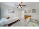 Cozy Bedroom features a twin bed and a crib, with wall decor and natural light at 5025 Willing Ct, Fort Mill, SC 29707