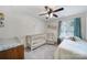 Bright Bedroom features a crib, a twin bed, and a comfortable chair with ample natural light at 5025 Willing Ct, Fort Mill, SC 29707