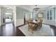 Elegant dining room featuring a chandelier, hardwood floors, and wainscoting details at 5025 Willing Ct, Fort Mill, SC 29707