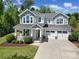 Charming two-story home featuring a welcoming front porch and three-car garage with great curb appeal at 5025 Willing Ct, Fort Mill, SC 29707