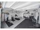Garage converted to a home gym, equipped with machines, weights, and ample workout space at 5025 Willing Ct, Fort Mill, SC 29707